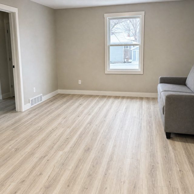 Wood-look luxury vinyl plank floor running through a family room